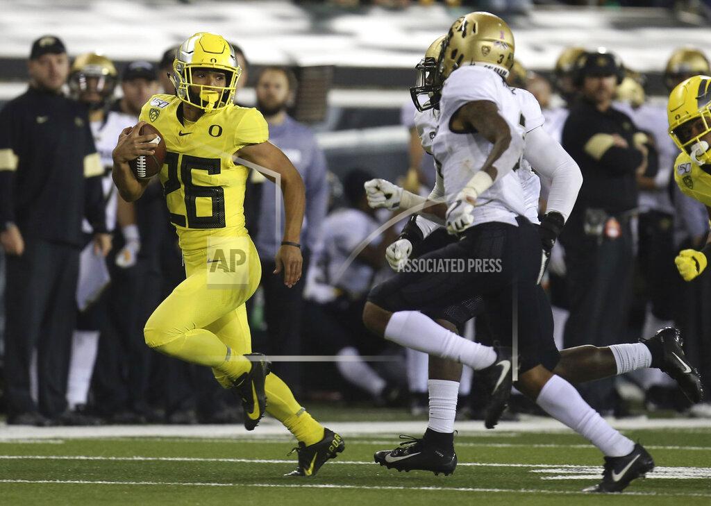 Chris Pietsch Oregon's Travis Dye, left, breaks for a big gain against Colorado in the fourth quarter of an NCAA college football game Friday, Oct. 11, 2019, in Eugene, Ore. (AP Photo/Chris Pietsch)