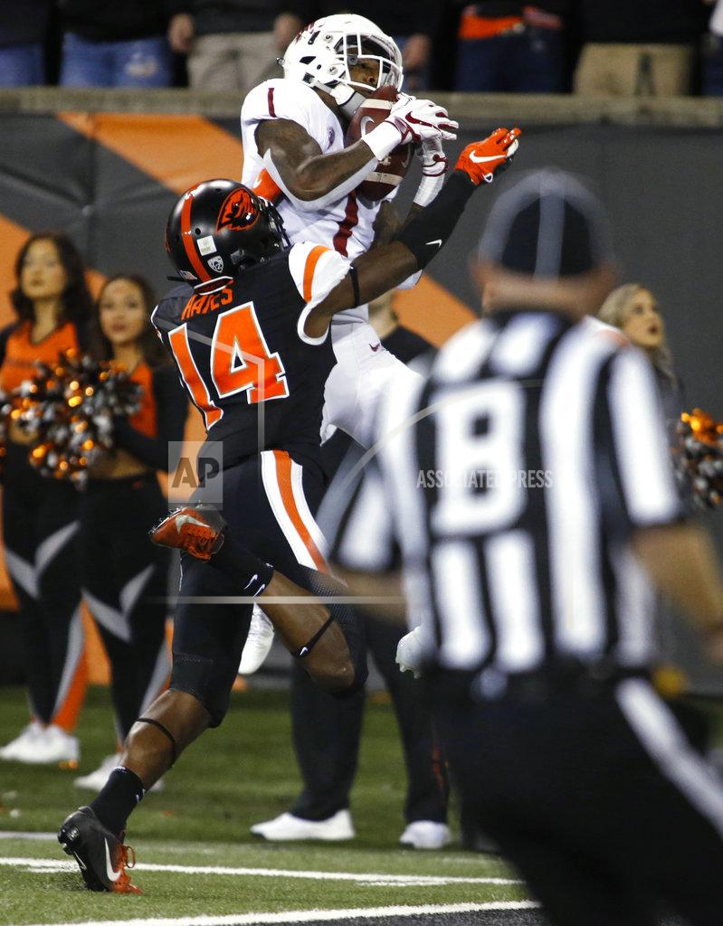 Timothy J. Gonzalez Washington State's Tay Martin (1) goes over Oregon State's Kaleb Hayes (14) for a touchdown catch during the first half of an NCAA college football in Corvallis, Ore., Saturday, Oct. 6, 2018. (AP Photo/Timothy J. Gonzalez)