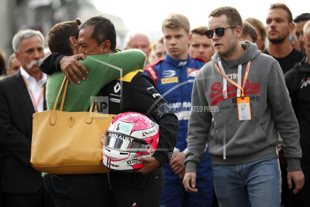 Francisco Seco The mother, left, and brother, second right, of Anthoine Hubert during a moment of silence for Formula 2 driver Anthoine Hubert at the Belgian Formula One Grand Prix circuit in Spa-Francorchamps, Belgium, Sunday, Sept. 1, 2019. The 22-year-old Hubert died following an estimated 160 mph (257 kph) collision on Lap 2 at the high-speed Spa-Francorchamps track, which earlier Saturday saw qualifying for Sunday's Formula One race. (AP Photo/Francisco Seco)