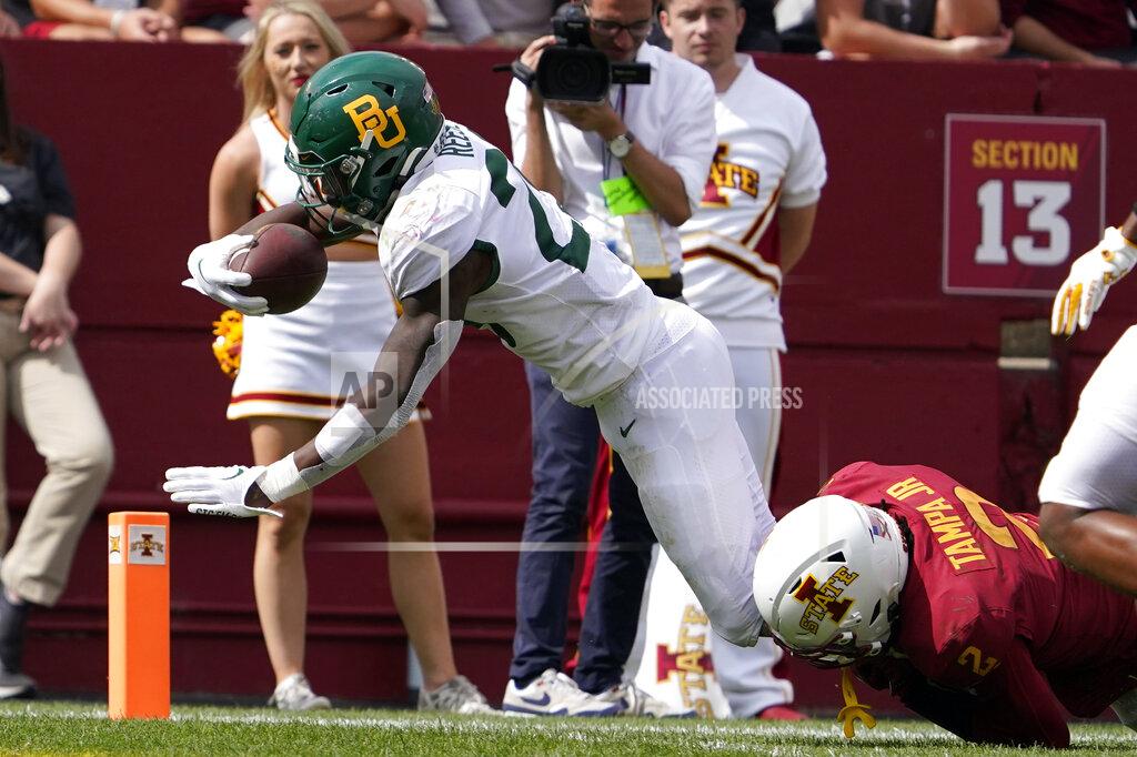 Charlie Neibergall Baylor running back Richard Reese (29) scores on a 19-yard touchdown run ahead of Iowa State defensive back T.J. Tampa (2) during the second half of an NCAA college football game, Saturday, Sept. 24, 2022, in Ames, Iowa. Baylor won 31-24. (AP Photo/Charlie Neibergall)