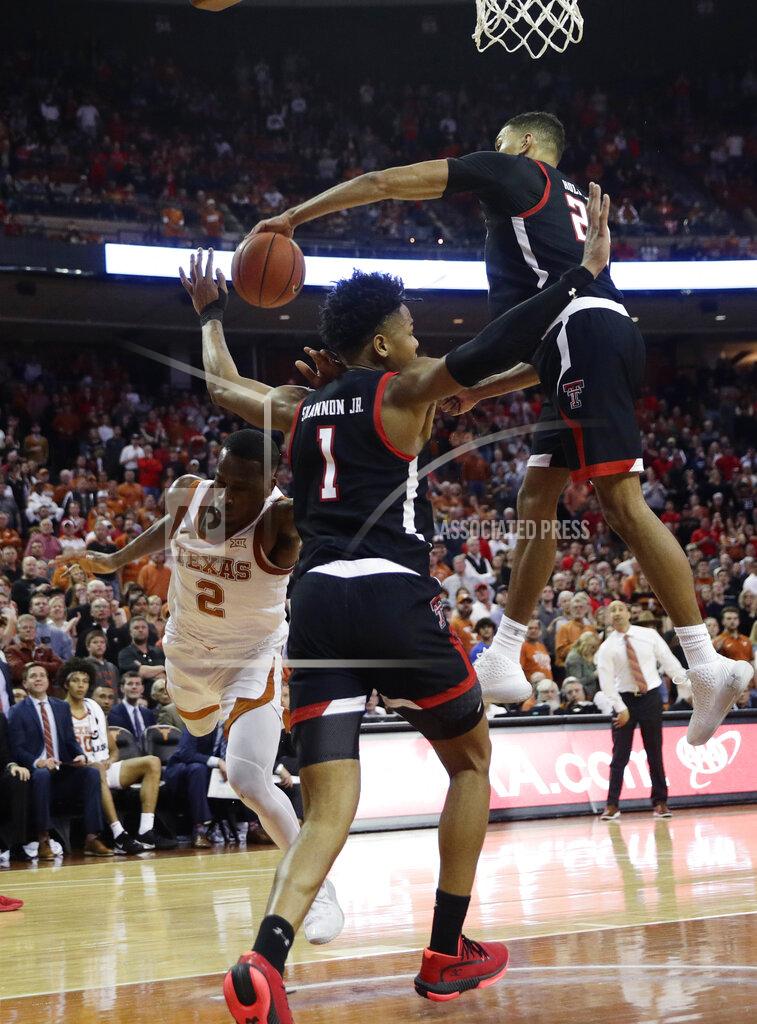 Eric Gay Texas guard Matt Coleman III (2) has his shot blocked by Texas Tech forward TJ Holyfield (22) during the second half of an NCAA college basketball game, Saturday, Feb. 8, 2020, in Austin, Texas. Texas Tech won 62-57. (AP Photo/Eric Gay)
