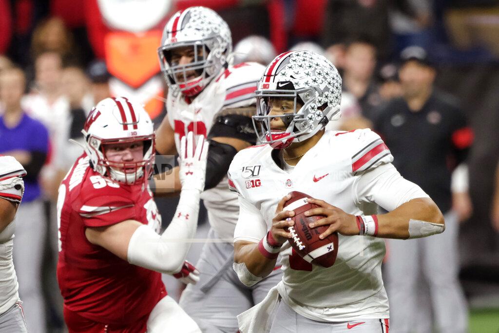 Aj Mast Ohio State quarterback Justin Fields, right, looks for a receiver during the second half of the team's Big Ten championship NCAA college football game against Wisconsin, Saturday, Dec. 7, 2019, in Indianapolis. (AP Photo/AJ Mast)
