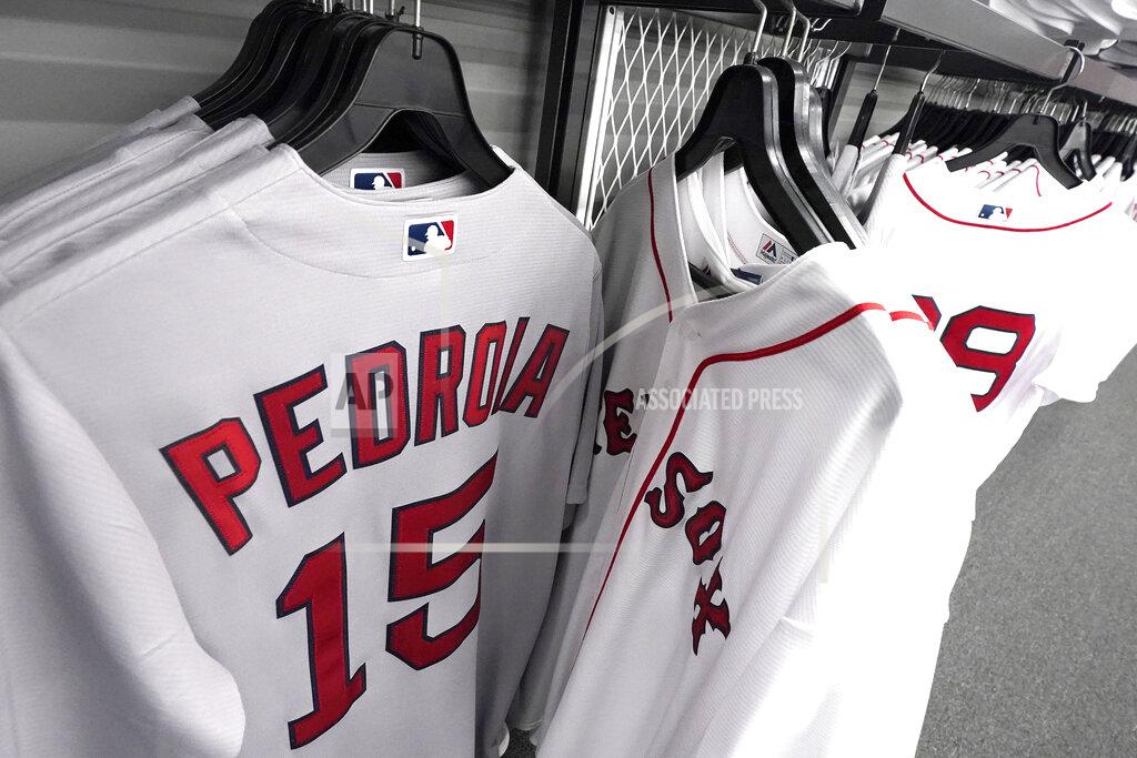 Elise Amendola Dustin Pedroia baseball jerseys are displayed at a Fenway Park pro shop, Monday Feb. 1, 2021, in Boston. Pedroia, who was the 2007 Rookie of the Year and the AL MVP in his second season, retired Monday, Feb. 1, 2021. (AP Photo/Elise Amendola)