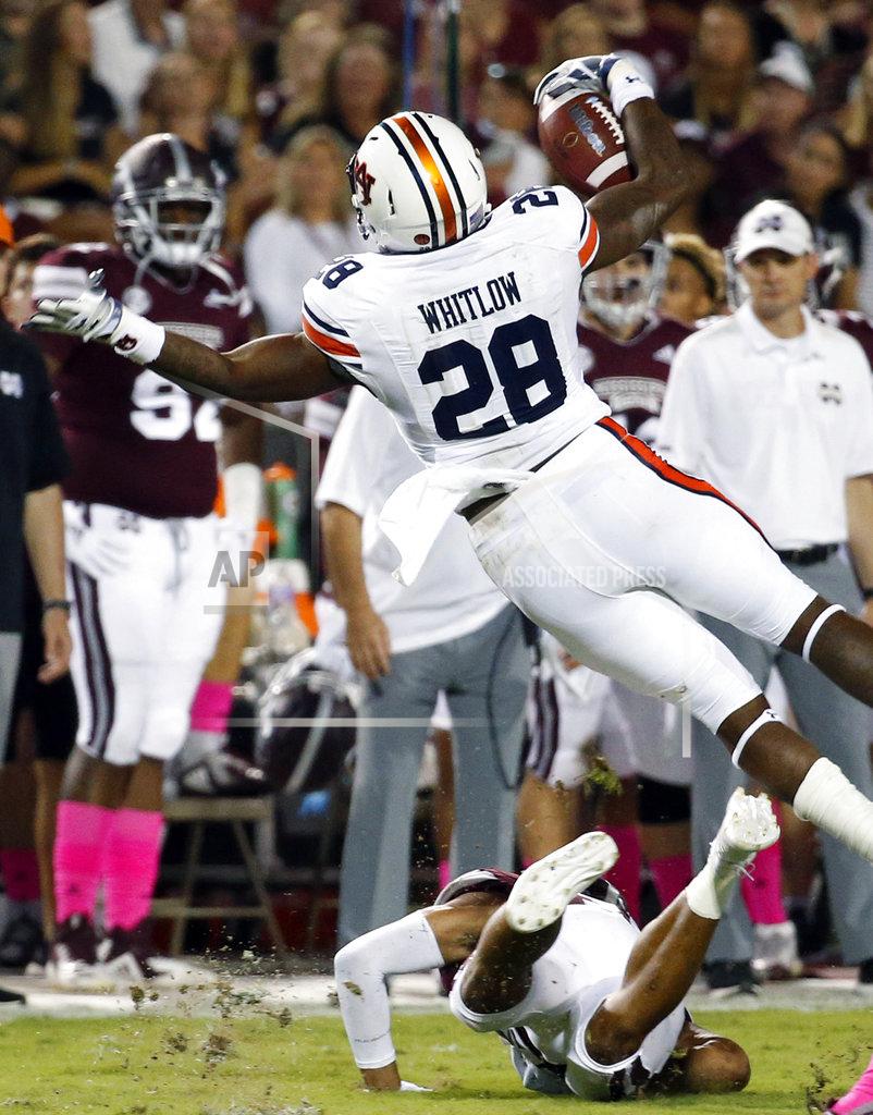 Rogelio V. Solis Auburn running back JaTarvious Whitlow (28) is knocked off his feet by a Mississippi State defender as he runs during the first half of their NCAA college football game in Starkville, Miss., Saturday, Oct. 6 2018. (AP Photo/Rogelio V. Solis)