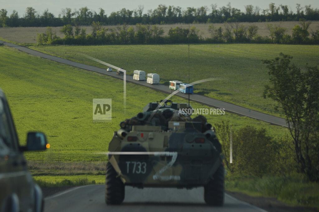 Alexei Alexandrov Buses with Ukrainian servicemen evacuated from the besieged Mariupol's Azovstal steel plant travel accompany Russian APC's to a prison in Olyonivka, territory under the government of the Donetsk People's Republic, eastern Ukraine, Tuesday, May 17, 2022. More than 260 fighters, some severely wounded, were pulled from a steel plant on Monday that is the last redoubt of Ukrainian fighters in the city and transported to two towns controlled by separatists, officials on both sides said. (AP Photo/Alexei Alexandrov)
