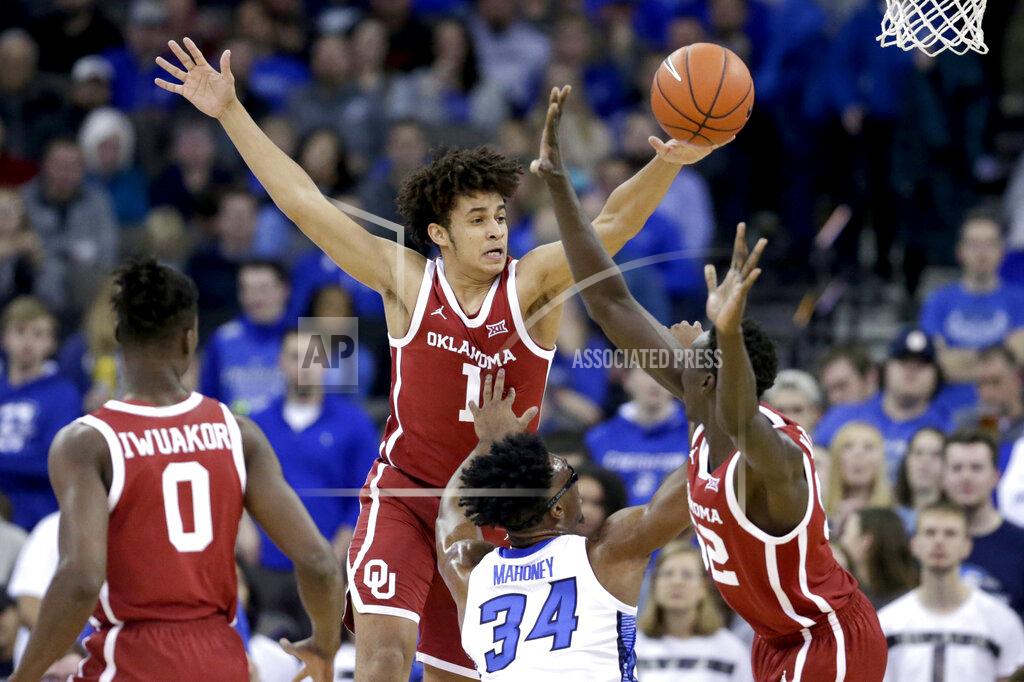 Nati Harnik Oklahoma's Jalen Hill (1) and Kur Kuath (52) defend against Creighton's Denzel Mahoney (34) during the first half of an NCAA college basketball game in Omaha, Neb., Tuesday, Dec. 17, 2019. (AP Photo/Nati Harnik)