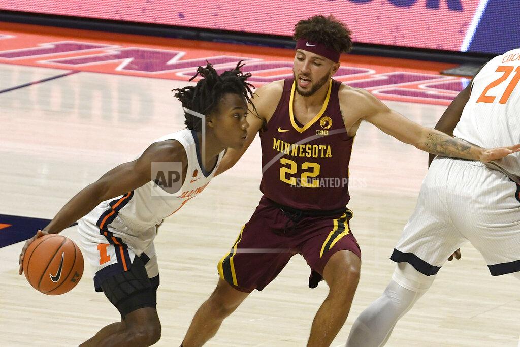 Holly Hart Illinois guard Ayo Dosunmu (11) powers past Minnesota's guard Gabe Kalscheur (22) in the first half of an NCAA college basketball game Tuesday, Dec. 15, 2020, in Champaign, Ill. (AP Photo/Holly Hart)