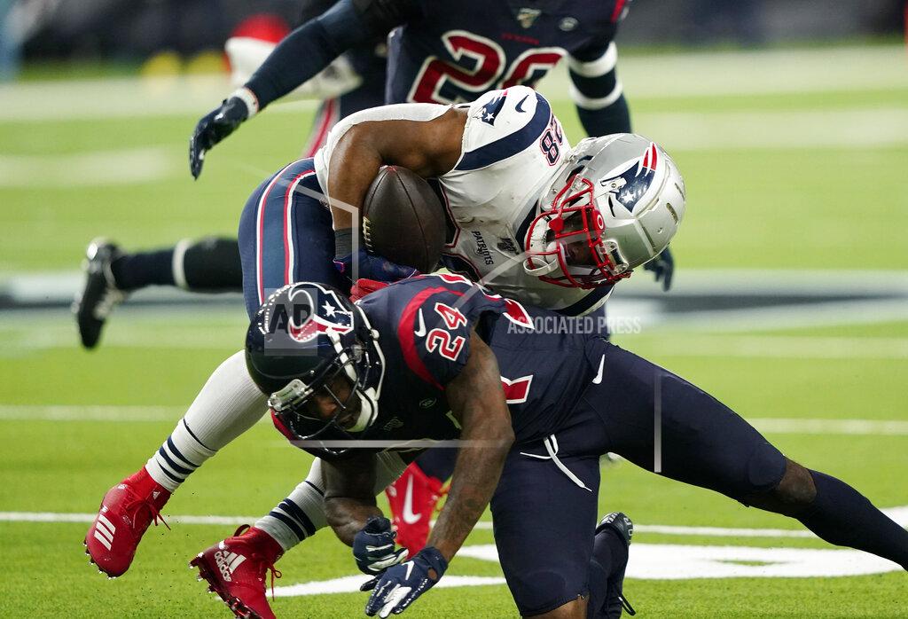 David J. Phillip New England Patriots running back James White (28) is hit by Houston Texans cornerback Johnathan Joseph (24) on a run during the first half of an NFL football game Sunday, Dec. 1, 2019, in Houston. (AP Photo/David J. Phillip)