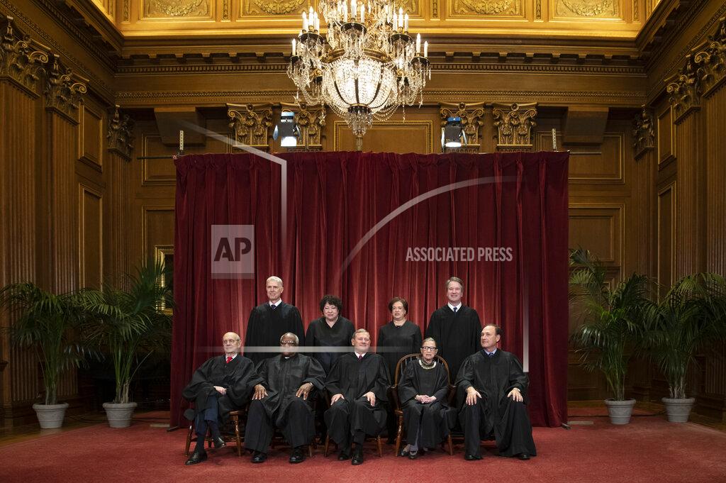 FILE - In this Nov. 30, 2018, file photo, the justices of the U.S. Supreme Court gather for a formal group portrait to include a new Associate Justice, top row, far right, at the Supreme Court Building in Washington. Seated from left: Associate Justice Stephen Breyer, Associate Justice Clarence Thomas, Chief Justice of the United States John G. Roberts, Associate Justice Ruth Bader Ginsburg and Associate Justice Samuel Alito Jr. Standing behind from left: Associate Justice Neil Gorsuch, Associate Justice Sonia Sotomayor, Associate Justice Elena Kagan and Associate Justice Brett M. Kavanaugh. (AP Photo/J. Scott Applewhite, File)