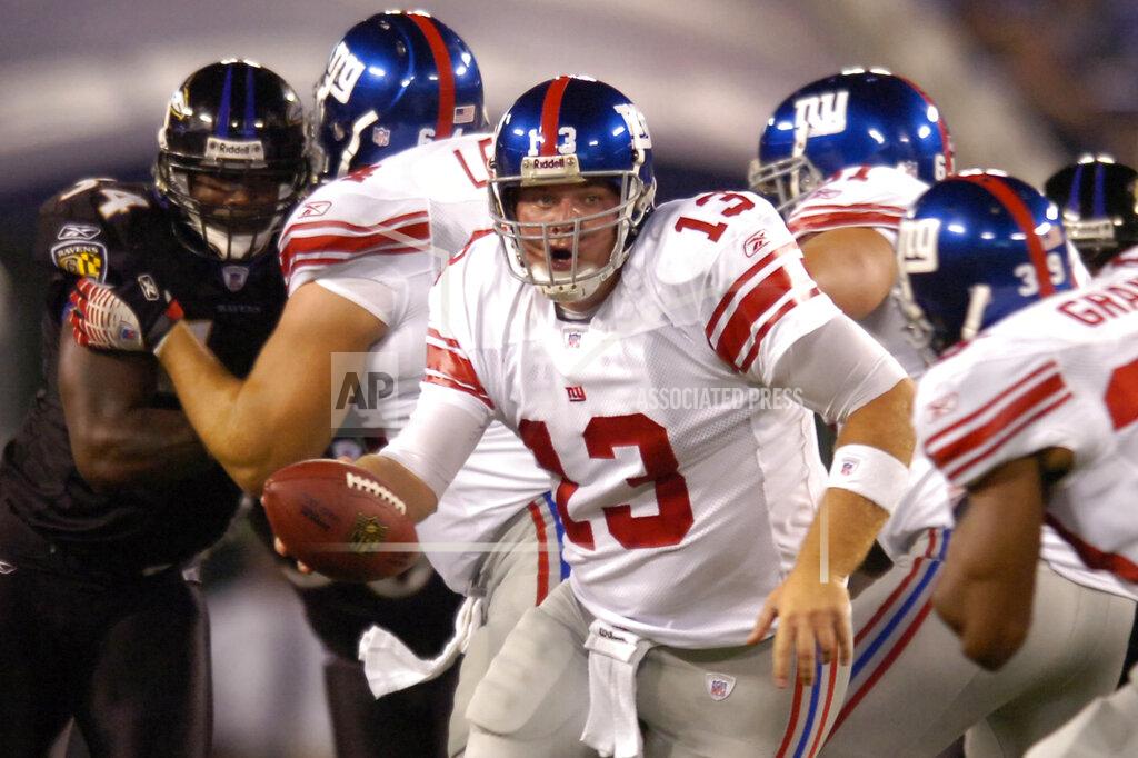 Gail Burton FILE - In this Aug. 19, 2007, file photo, New York Giants quarterback Jared Lorenzen (13) hands off to running back Ryan Grant (39) during the team's preseason NFL football game against the Baltimore Ravens in Baltimore. Lorenzen, a husky left-handed quarterback who set multiple Kentucky passing and offensive records before backing up Eli Manning on the Giants’ Super Bowl-winning 2007 team, has died. He was 38. A release from the school said Lorenzen’s family announced his death on Wednesday, July 3. (AP Photo/Gail Burton, File)