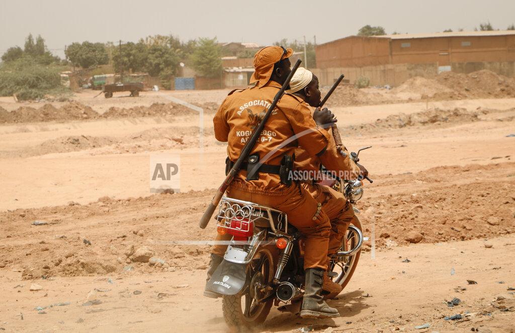 Sam Mednick Local defense force fighters drive on a motorbike during an event to inaugurate a new chapter of the group in Ouagadougou, Burkina Faso, Saturday, March 14, 2020. In an effort to combat rising jihadist violence, Burkina Faso’s military has recruited volunteers to help it fight militants. (AP Photo/Sam Mednick)