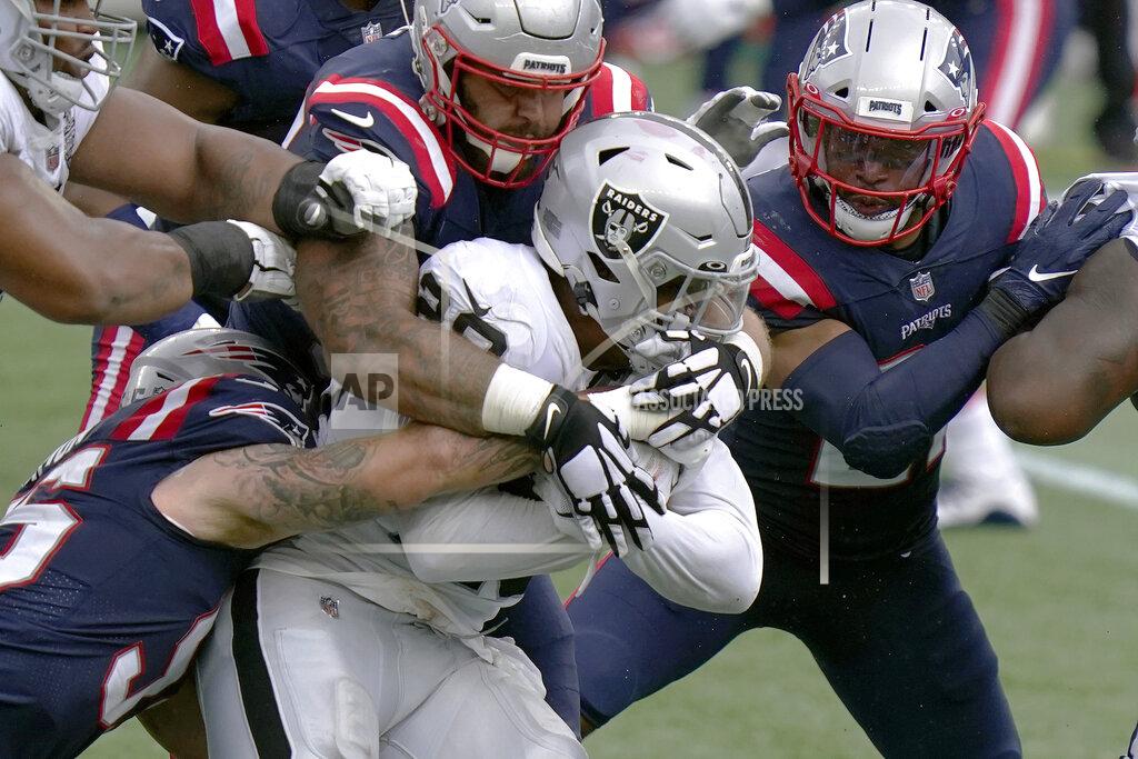 Steven Senne New England Patriots defenders combine to tackle Las Vegas Raiders running back Josh Jacobs (28) in the first half of an NFL football game, Sunday, Sept. 27, 2020, in Foxborough, Mass. (AP Photo/Steven Senne)