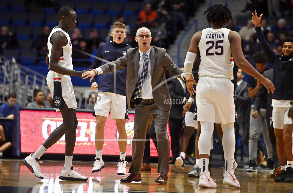 Jessica Hill Connecticut head coach Dan Hurley, center, reacts as his players run to him during a timeout the first half of an NCAA college basketball game against Maine, Sunday, Dec. 1, 2019, in Hartford, Conn. (AP Photo/Jessica Hill)