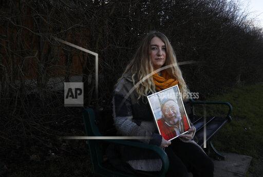 FILE - In this Friday, Jan. 22, 2021 file photo, Jo Goodman holds a portrait of her late father Stuart as she poses for a photo in London. Britain's Prime Minister Boris Johnson will on Tuesday, Sept. 28 finally meet with members of the COVID-19 Bereaved Families for Justice campaigning group, who for more than a year have sharply criticized his handling of the coronavirus pandemic. Johnson's Downing Street office confirmed Monday that the prime minister will hold a “private meeting” with members of the group. (AP Photo/Alastair Grant, file)