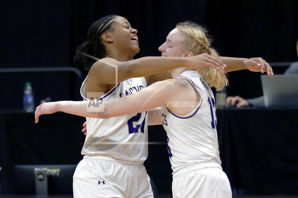 Michael Wyke Stephen F. Austin forward Aiyana Johnson (21) and guard Stephanie Visscher (13) hug as the buzzer sounds on their win against Sam Houston State after an NCAA college basketball game for the Southland Conference women's tournament championship Sunday, March 14, 2021, in Katy, Texas. (AP Photo/Michael Wyke)
