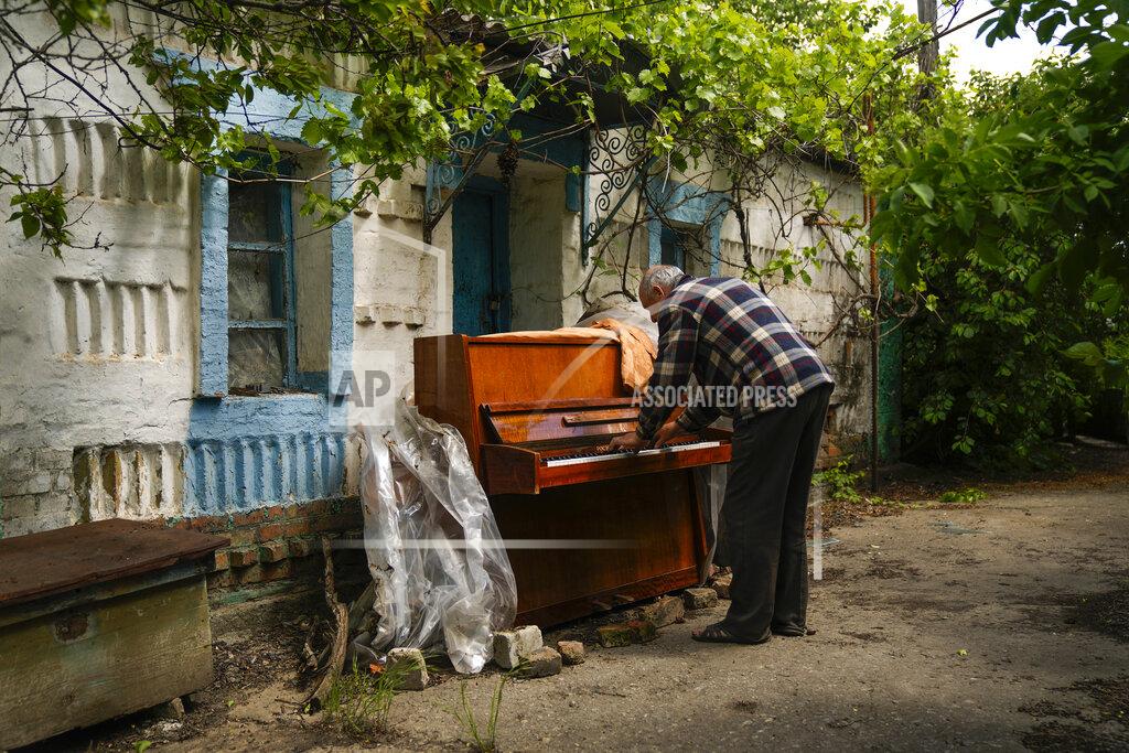 Francisco Seco Local resident Anatolii Virko plays a piano outside a house likely damaged after a Russian bombing in Velyka Kostromka village, Ukraine, Thursday, May 19, 2022. (AP Photo/Francisco Seco)