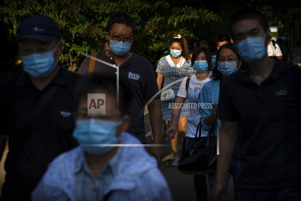Mark Schiefelbein People wearing face masks to protect against the coronavirus walk along a street in the central business district in Beijing, Wednesday, Sept. 2, 2020. Even as China has largely controlled the outbreak, the coronavirus is still surging across parts of the world. (AP Photo/Mark Schiefelbein)
