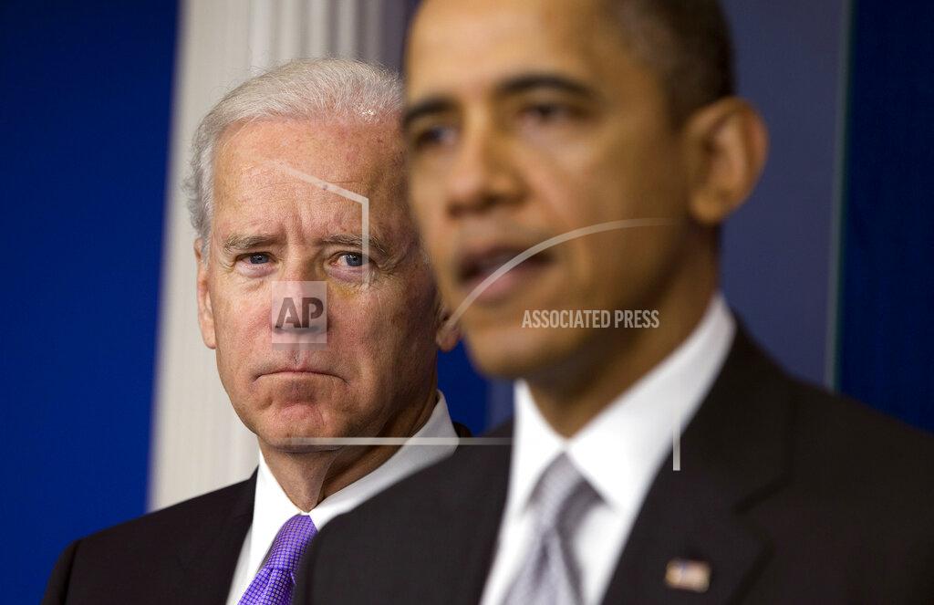 Evan Vucci FILE - Vice President Joe Biden, left, listens as President Barack Obama announces that Biden will lead an administration-wide effort to curb gun violence in response to the Connecticut school shooting, during a news conference in the briefing room of the White House on Dec. 19, 2012 in Washington. (AP Photo/ Evan Vucci, File)