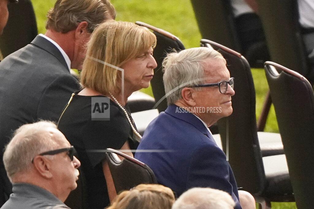 Tony Dejak Ohio governor Mike DeWine sits with his wife, Fran, during the funeral for Navy Corpsman Maxton Soviak at Edison High School Stadium, Monday, Sept. 13, 2021, in Milan, Ohio. Soviak was one of 13 U.S. troops killed in a suicide bombing at Afghanistan's Kabul airport on Aug. 26. (AP Photo/Tony Dejak)