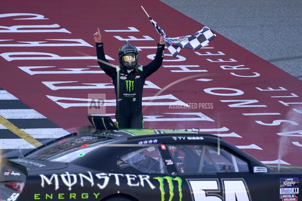 Paul Sancya Ty Gibbs celebrates winning the New Holland 250 NASCAR Xfinity Series auto race at the Michigan International Speedway in Brooklyn, Mich., Saturday, Aug. 6, 2022. (AP Photo/Paul Sancya)