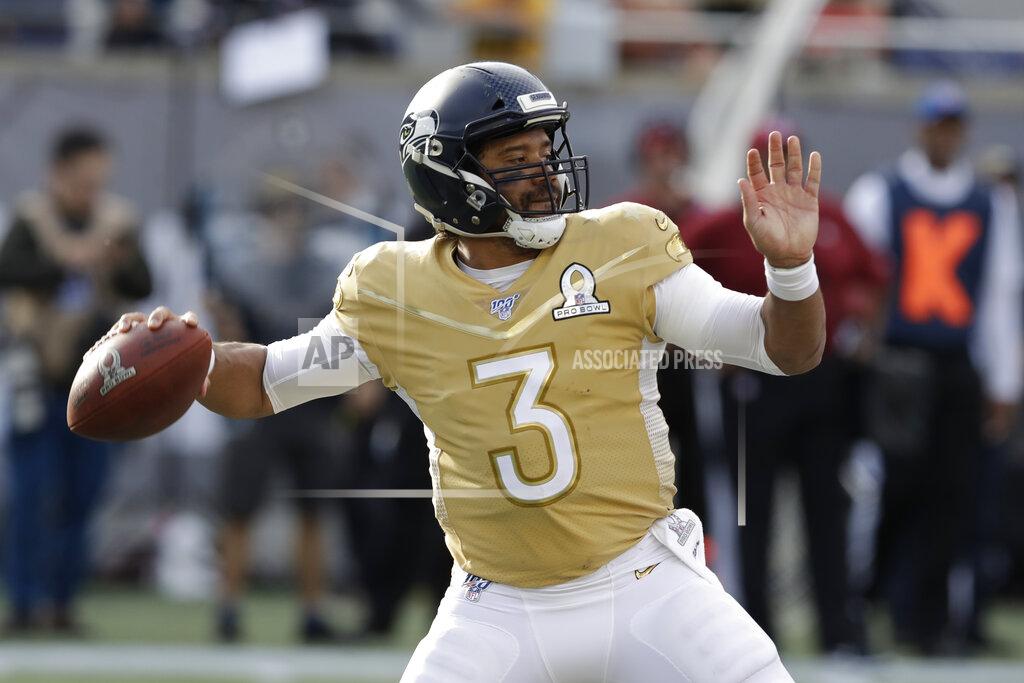 Chris O'meara NFC quarterback Russell Wilson, of the Seattle Seahawks, (3) looks to pass, during the first half of the NFL Pro Bowl football game against the AFC, Sunday, Jan. 26, 2020, in Orlando, Fla. (AP Photo/Chris O'Meara)