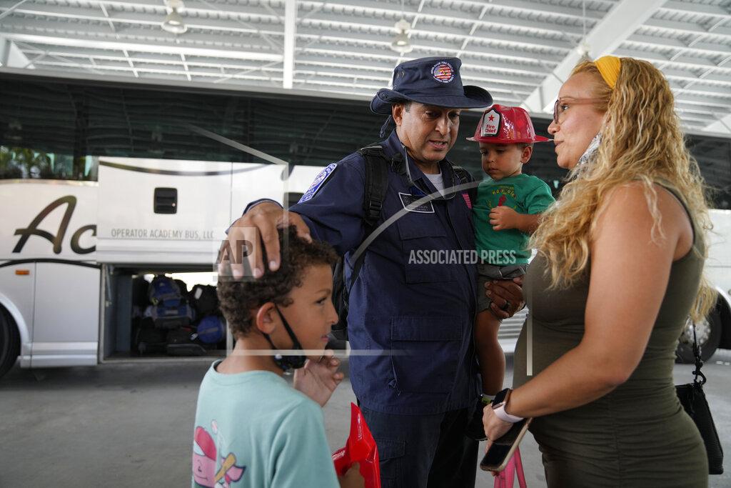 Rebecca Blackwell Enrique Calvo greets his sons Alec, 6, Enrique, 2, and wife Joceline, as members of Miami-Dade Fire Rescue's urban search and rescue team are reunited with their families after weeks of working on the rubble pile at the collapsed Champlain Towers South condominium, on Friday, July 23, 2021, in Doral, Fla. (AP Photo/Rebecca Blackwell)
