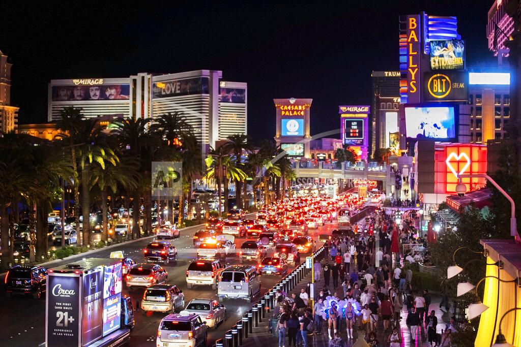 Benjamin Hager FILE - In this March 19, 2021, file photo, vehicles and crowds move along the strip in Las Vegas. One big casino operator says it'll begin charging parking fees again at events and its Las Vegas Strip resorts. The move by MGM Resorts International marks the end of free parking that lingered after pandemic-related casino shutdowns. In a statement on Tuesday, May 11, 2021, the company cited signs of economic recovery and increasing numbers of guests. (Benjamin Hager/Las Vegas Review-Journal via AP, File)
