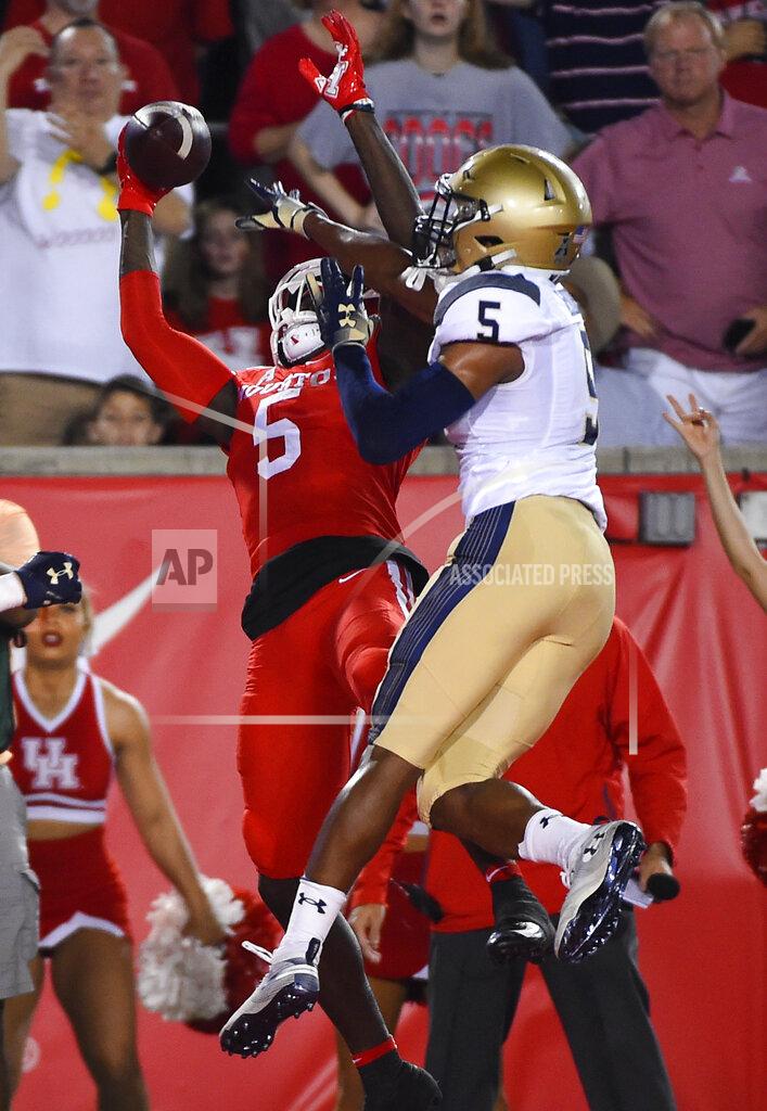 Eric Christian Smith Houston wide receiver Marquez Stevenson, left, misses a pass in the end zone as Navy cornerback Michael McMorris defends during the first half of an NCAA college football game, Saturday, Nov. 30, 2019, in Houston. (AP Photo/Eric Christian Smith)