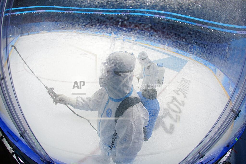 Matt Slocum A worker disinfects the ice rink after the women's gold medal hockey game at the 2022 Winter Olympics, Thursday, Feb. 17, 2022, in Beijing. (AP Photo/Matt Slocum)
