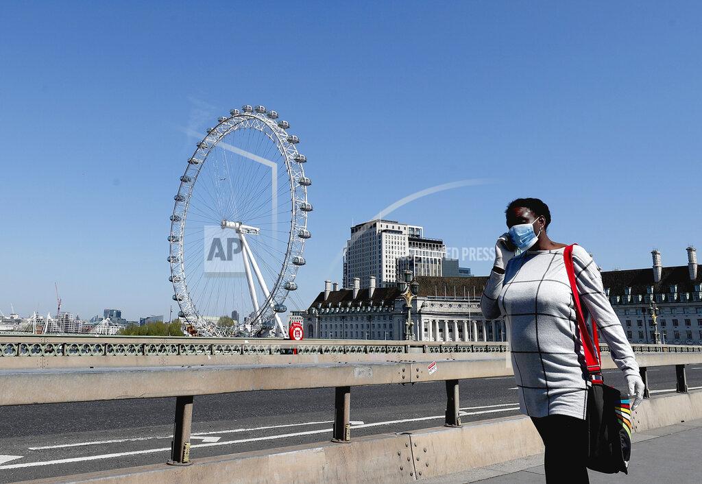 Frank Augstein A woman wearing a protection mask to protect against coronavirus walks over Westminster Bridge in London, Wednesday April 22, 2020 during the COVID-19 lockdown. (AP Photo/Frank Augstein)