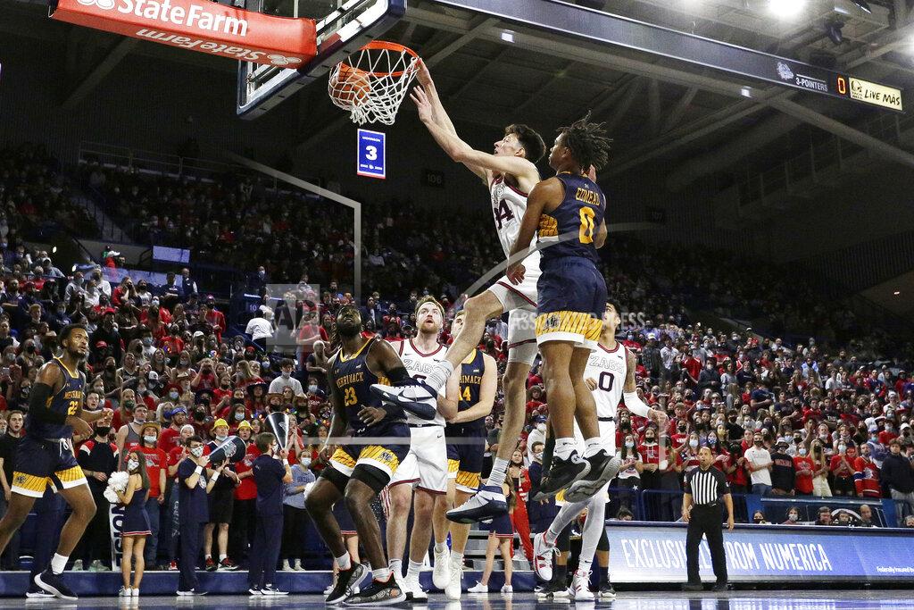 Young Kwak Gonzaga center Chet Holmgren, center left, dunks next to Merrimack guard Malik Edmead during the first half of an NCAA college basketball game, Thursday, Dec. 9, 2021, in Spokane, Wash. (AP Photo/Young Kwak)