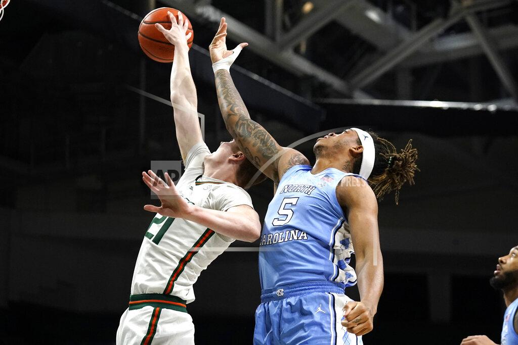 Lynne Sladky Miami forward Sam Waardenburg 921) and North Carolina forward Armando Bacot (5) go for a rebound during the first half of an NCAA college basketball game, Tuesday, Jan. 18, 2022, in Coral Gables, Fla. (AP Photo/Lynne Sladky)