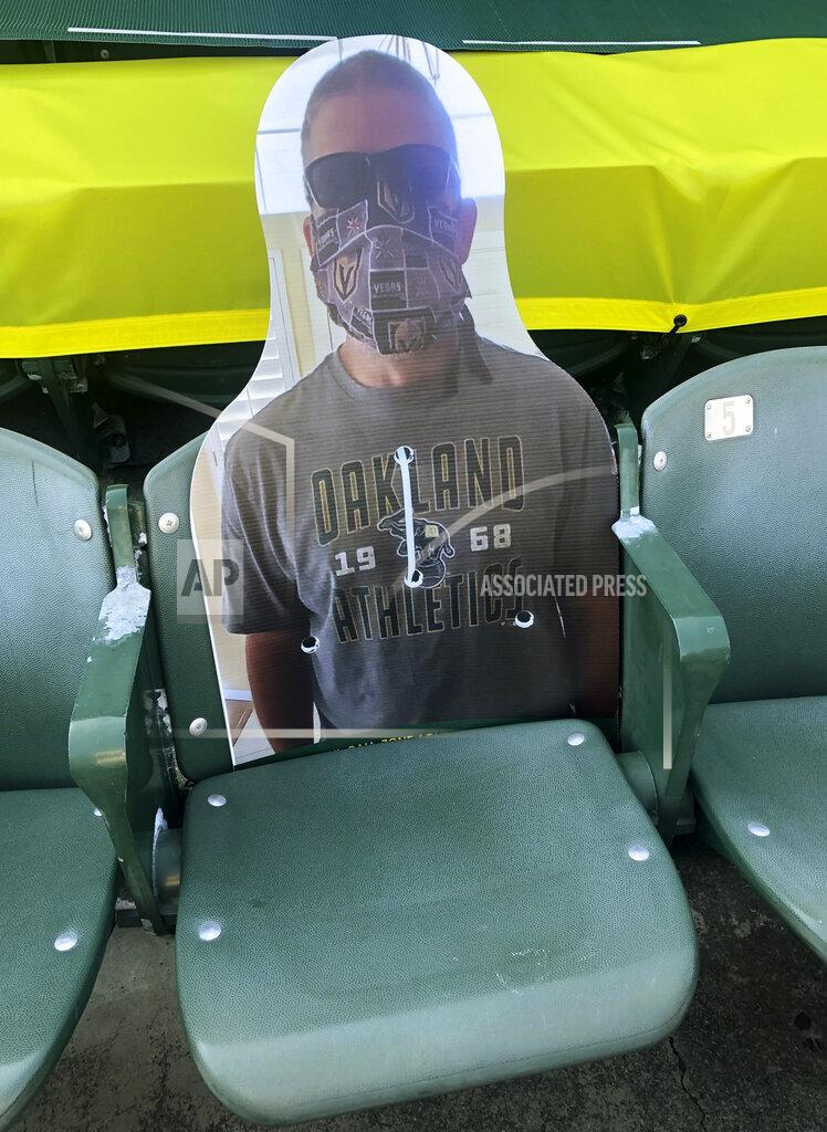Ben Margot A cardboard cutout depicting A's fan Richard Lovelady of Henderson, Nev., is displayed in a section of the Oakland Coliseum after the baseball game between the Los Angeles Angels and the Oakland Athletics on Monday, July 27, 2020, in Oakland, Calif. An approach taken by some teams is sending out souvenirs to fans if their cardboard cutout gets hit by a ball. The Longtime A's supporter lucked out last Friday night when his cutout — section 126, row 24, seat 4 — was struck by Matt Olson's foul.(AP Photo/Ben Margot)