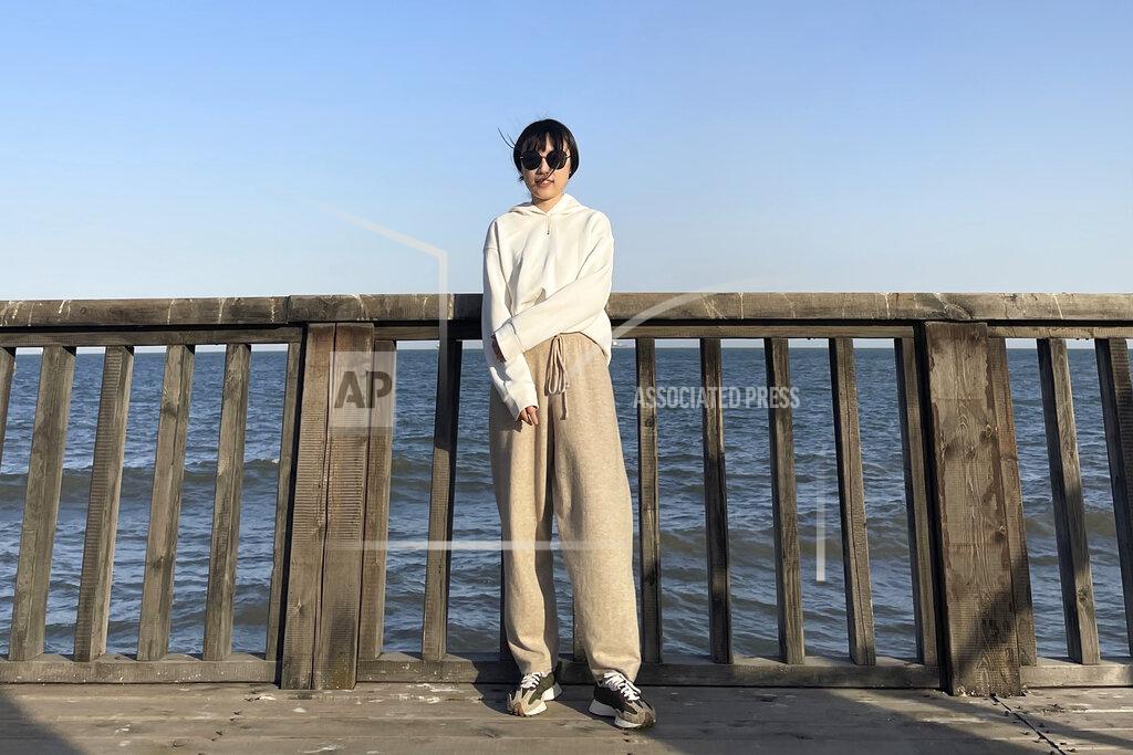 Uncredited In this April 3, 2021, photo and released by Monica Ma, Monica Ma poses for a photo along the coast of Qinhuangdao in northern China's Hebei province. Ma is among at least 500 students the Chinese government says have been rejected under a policy, aimed at blocking Beijing from obtaining U.S. technology with possible military uses, issued last year by then U.S. President Donald Trump. (Monica Ma via AP)