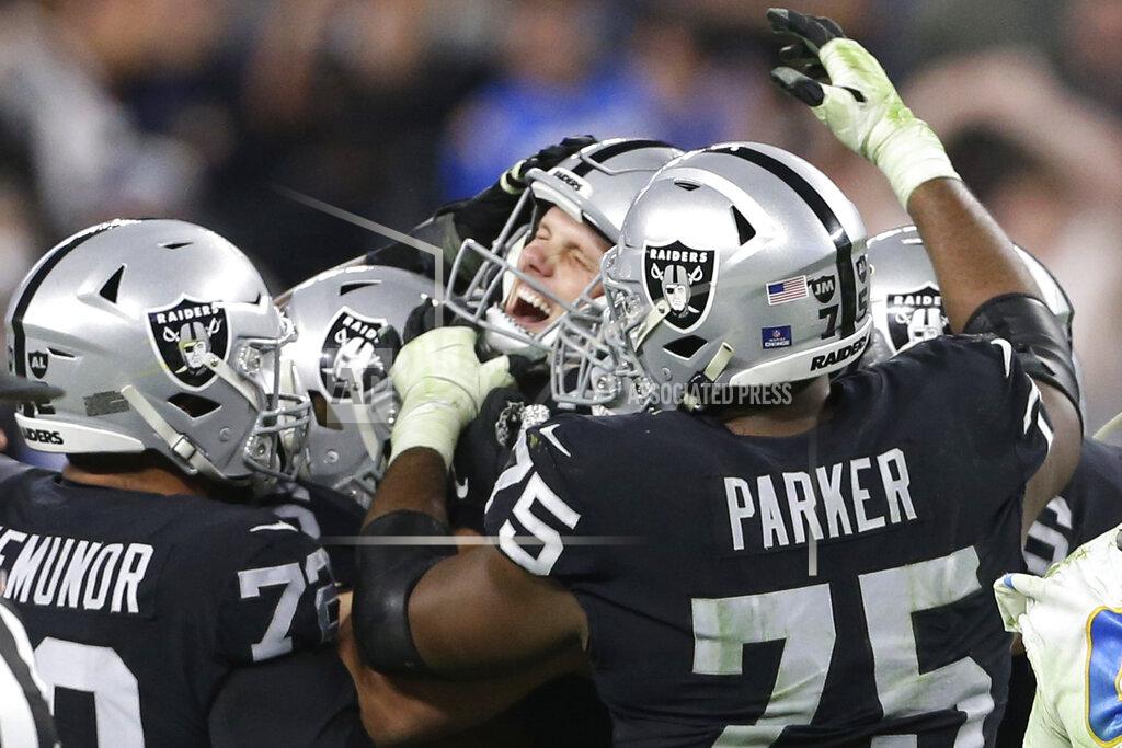 Ellen Schmidt Las Vegas Raiders kicker Daniel Carlson, center, celebrates after kicking the game-winning field goal against the Los Angeles Chargers during overtime of an NFL football game, Sunday, Jan. 9, 2022, in Las Vegas. (AP Photo/Ellen Schmidt)