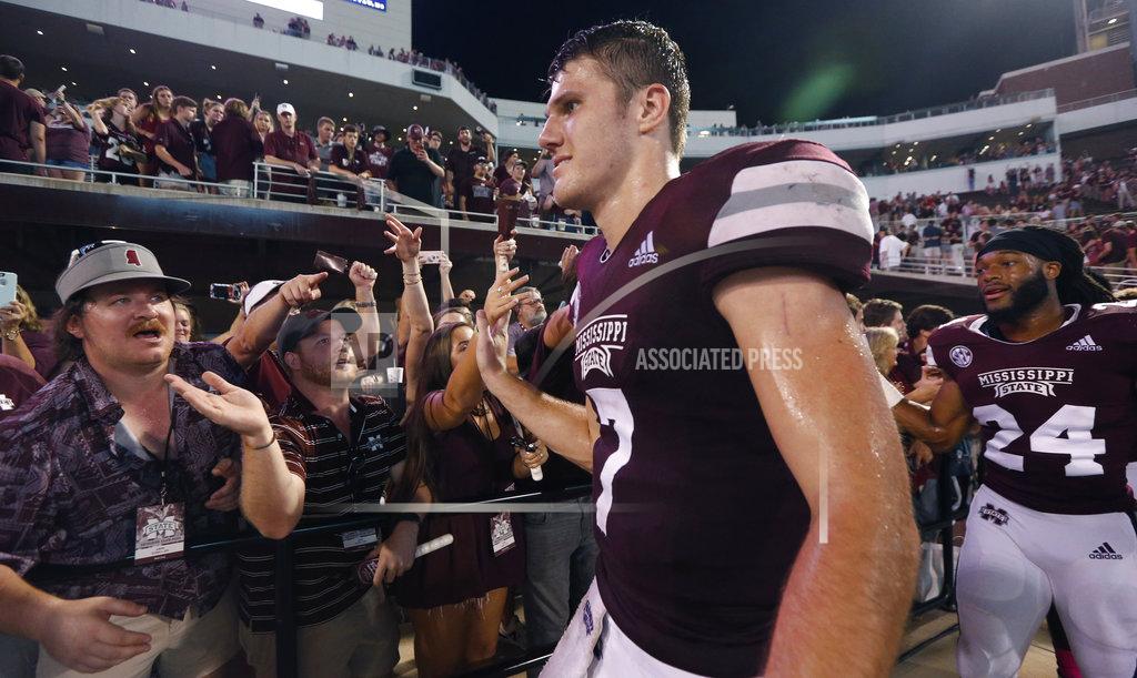 Rogelio V. Solis Mississippi State quarterback Nick Fitzgerald (7) and cornerback Chris Rayford (24) celebrate with fans after the team's 23-9 win over Auburn in an NCAA college football game in Starkville, Miss., Saturday, Oct. 6 2018. (AP Photo/Rogelio V. Solis)