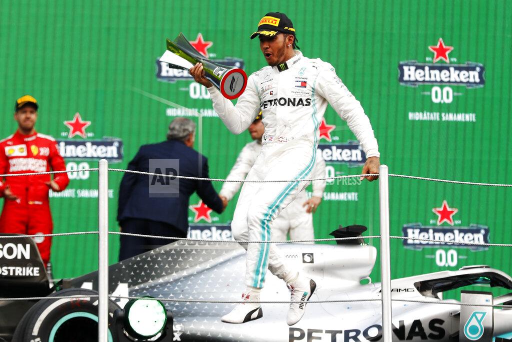 Mercedes driver Lewis Hamilton, of Britain, celebrates on the podium after winning the Formula One Mexico Grand Prix auto race at the Hermanos Rodriguez racetrack in Mexico City, Saturday, Oct. 26, 2019. (AP Photo/Eduardo Verdugo)