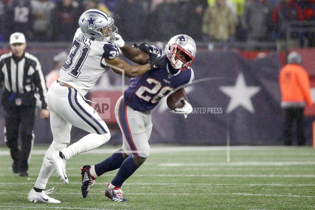 Elise Amendola New England Patriots running back Sony Michel, right, gives a stiff arm to Dallas Cowboys cornerback Byron Jones as he carries the ball in the second half of an NFL football game, Sunday, Nov. 24, 2019, in Foxborough, Mass. (AP Photo/Elise Amendola)