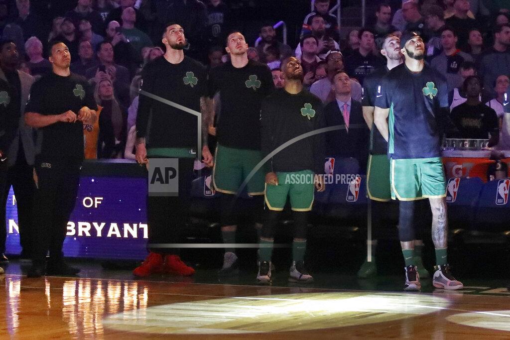 Boston Celtics players look top at a video tribute to the late Los Angeles Laker Kobe Bryant, before an NBA basketball game against the Golden State Warriors, Thursday, Jan. 30, 2020, in Boston. (AP Photo/Elise Amendola)