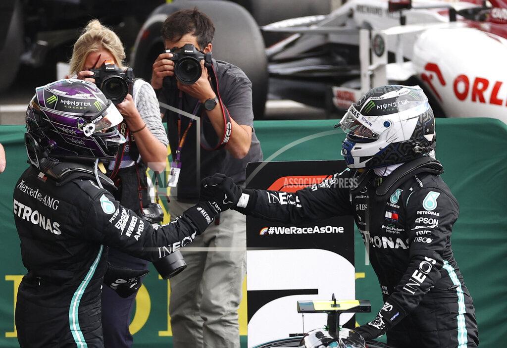 Lars Baron Race winner Mercedes driver Lewis Hamilton of Britain, left, celebrates with second placed Mercedes driver Valtteri Bottas of Finland after the Formula One Grand Prix at the Spa-Francorchamps racetrack in Spa, Belgium, Sunday, Aug. 30, 2020. (Lars Baron, Pool via AP)