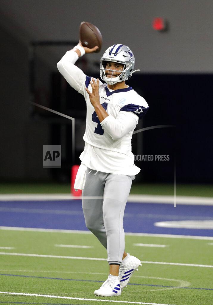 Dallas Cowboys quarterback Dak Prescott (4) throws a pass as he participates in drills at the team's NFL football training facility in Frisco, Texas, Wednesday, June 12, 2019. (AP Photo/Tony Gutierrez