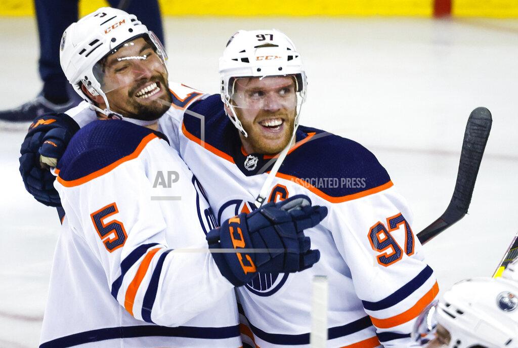 Jeff Mcintosh Edmonton Oilers center Connor McDavid, right, celebrates his goal against the Calgary Flames with defenseman Cody Ceci in overtime in Game 5 of an NHL hockey second-round playoff series Thursday, May 26, 2022, in Calgary, Alberta. (Jeff McIntosh/The Canadian Press via AP)