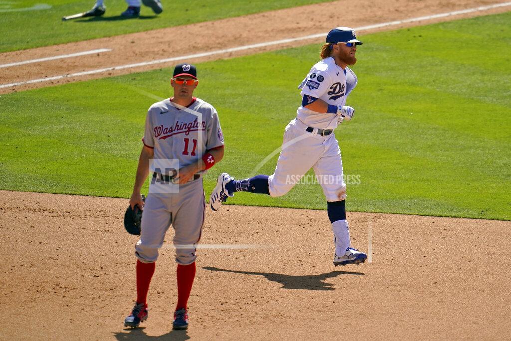 Marcio Jose Sanchez Los Angeles Dodgers' Justin Turner, right, rounds first base past Washington Nationals first baseman Ryan Zimmerman (11) after hitting a solo home run in the sixth inning of a baseball game, Friday, April 9, 2021, in Los Angeles. (AP Photo/Marcio Jose Sanchez)
