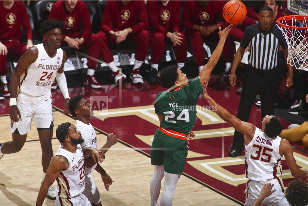 Phil Sears Miami guard Nijel Pack (24) makes a layup over the defense of Florida State guard Matthew Cleveland (35) in the first half of an NCAA college basketball game in Tallahassee, Fla., Tuesday, Jan. 24, 2023. (AP Photo/Phil Sears)