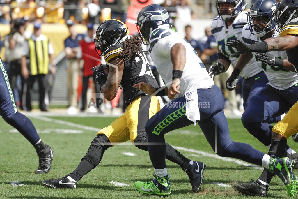 Gene J. Puskar Pittsburgh Steelers inside linebacker Mark Barron (26) runs with the ball past Seattle Seahawks quarterback Russell Wilson (3) after recovering a fumble in the first half of an NFL football game, Sunday, Sept. 15, 2019, in Pittsburgh. (AP Photo/Gene J. Puskar)