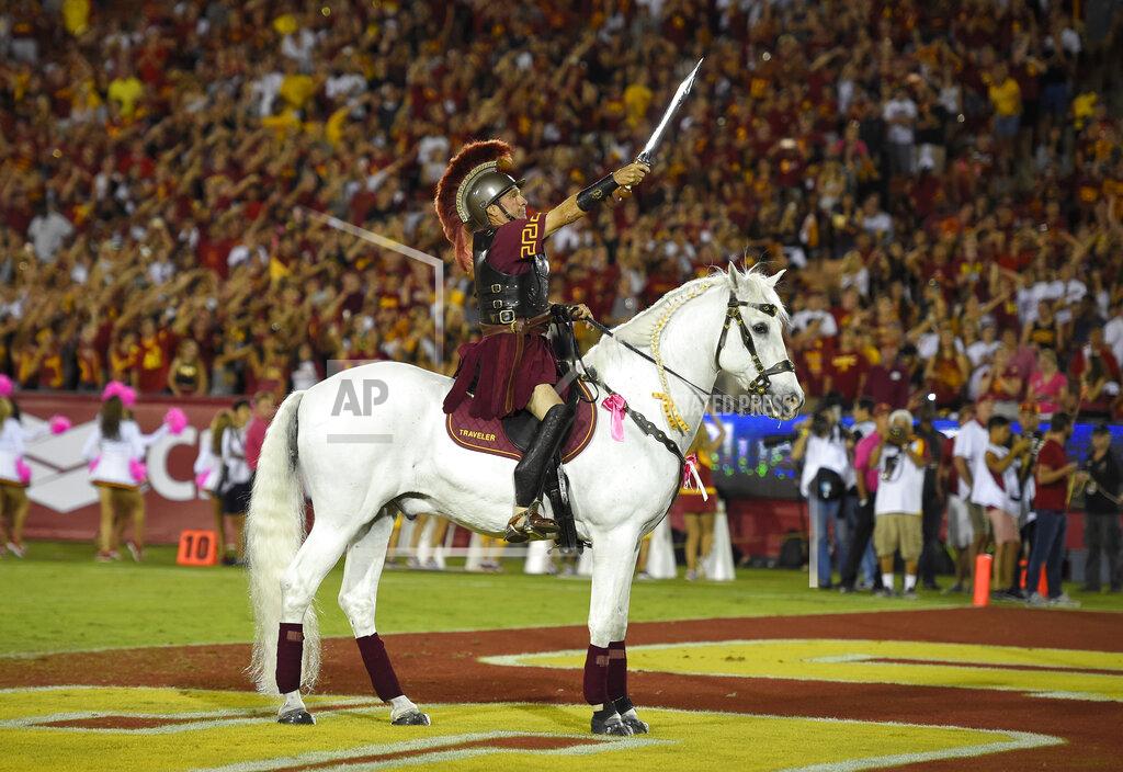 Mark J. Terrill Hector Aguilar rides Traveler VII during the second half of an NCAA college football game between Southern California and Utah, Saturday, Oct. 24, 2015, in Los Angeles. Football is being played in the Power Five conferences, but many of the longstanding traditions that go along with the games are on hold during the coronavirus pandemic. (AP Photo/Mark J. Terrill)
