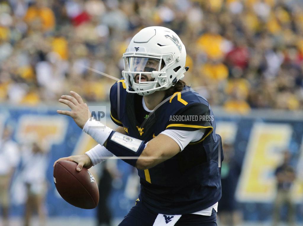 Ray Thompson FILE - In this Sept. 16, 2017, file phto, West Virginia quarterback Will Grier (7) is shown during an NCAA college football game against Delaware, in Morgantown, W.Va. West Virginia already has launched a Heisman campaign for Grier, the Associated Press preseason All-America first-team quarterback. West Virginia will play against Tennessee on Saturday. (AP Photo/Raymond Thompson, File)
