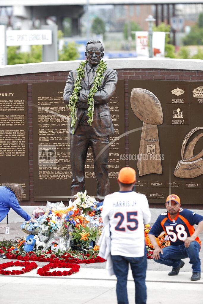 David Zalubowski Fans gather for photographs at the foot of a statue during a five-hour memorial for Denver Broncos owner Pat Bowlen Tuesday, June 18, 2019 in at Mile High Stadium, the NFL football team's home in Denver. Bowlen, who has owned the franchise for more than three decades, died last Thursday. (AP Photo/David Zalubowski)