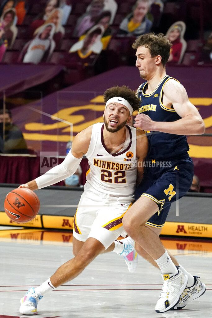 Jim Mone Minnesota's Gabe Kalscheur (22) drives around Michigan's Franz Wagner (21) in the first half of an NCAA college basketball game, Saturday, Jan. 16, 2021, in Minneapolis. (AP Photo/Jim Mone)