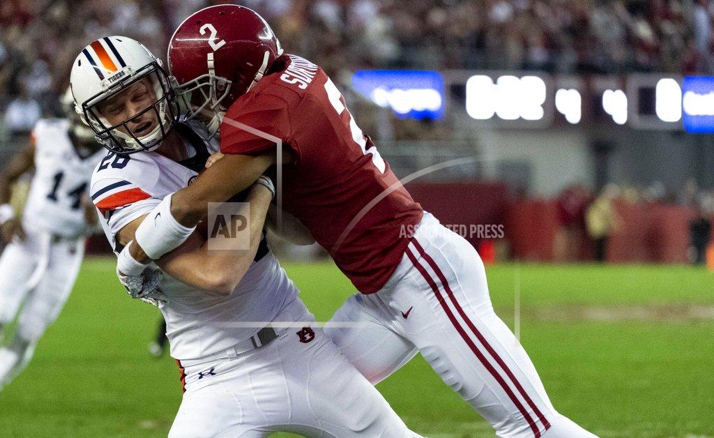 Vasha Hunt Alabama defensive back Patrick Surtain II (2) hits Auburn place-kicker Anders Carlson (26) to stop Auburn on a fake field goal on fourth down during the second half of an NCAA college football game Saturday, Nov. 24, 2018, in Tuscaloosa, Ala. (AP Photo/Vasha Hunt)
